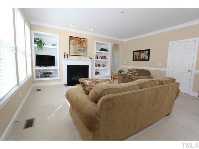 5807 Claribel Court Raleigh, NC 27612 - Photo 10 of 24 Built-in bookshelves surround the gas fireplace. Media center has wiring tubes for your electronic components. Den/Family/Great Room