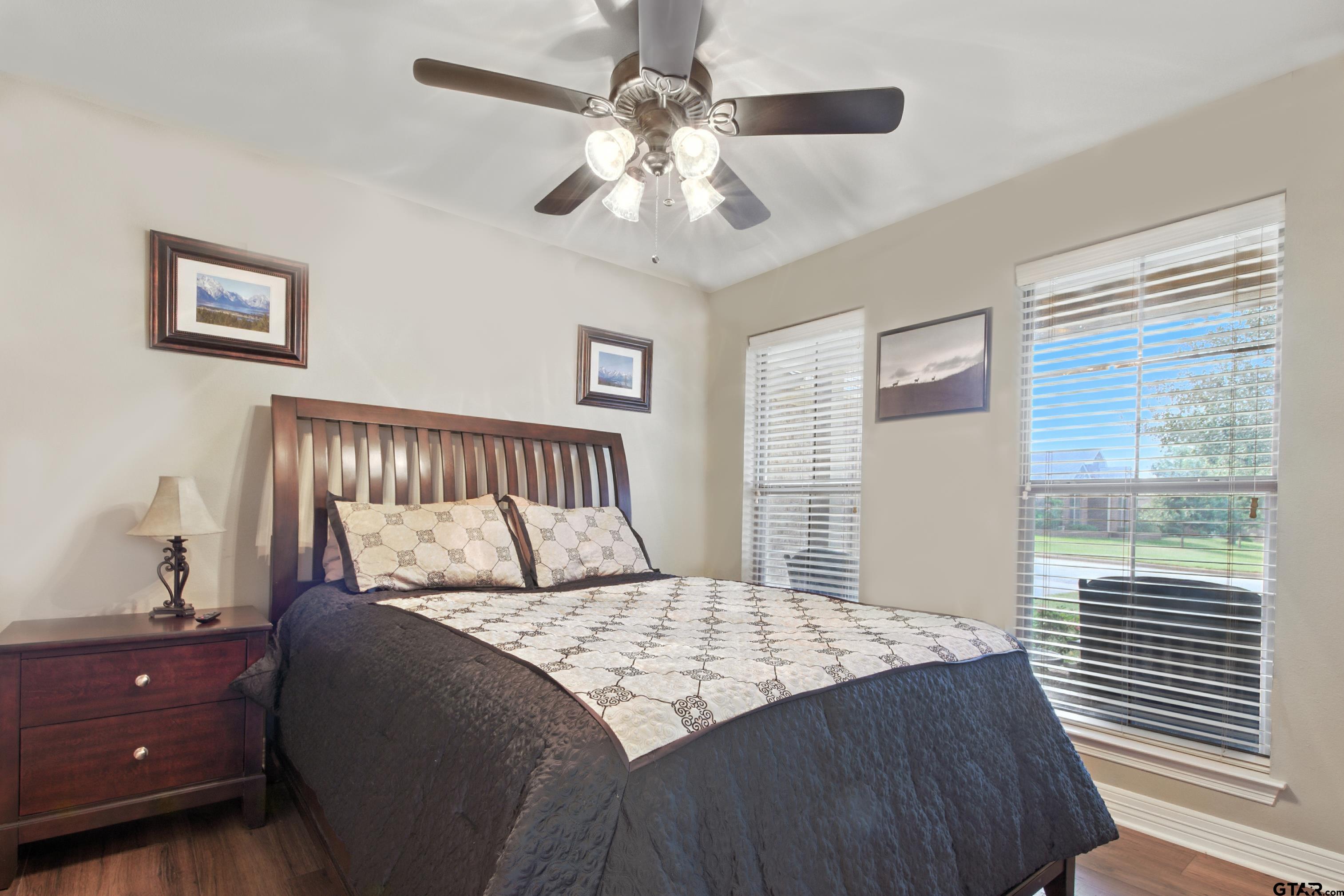 704 Windover Lane Bullard, TX 75757 - Photo 15 of 23 a bedroom with a large bed and a chandelier