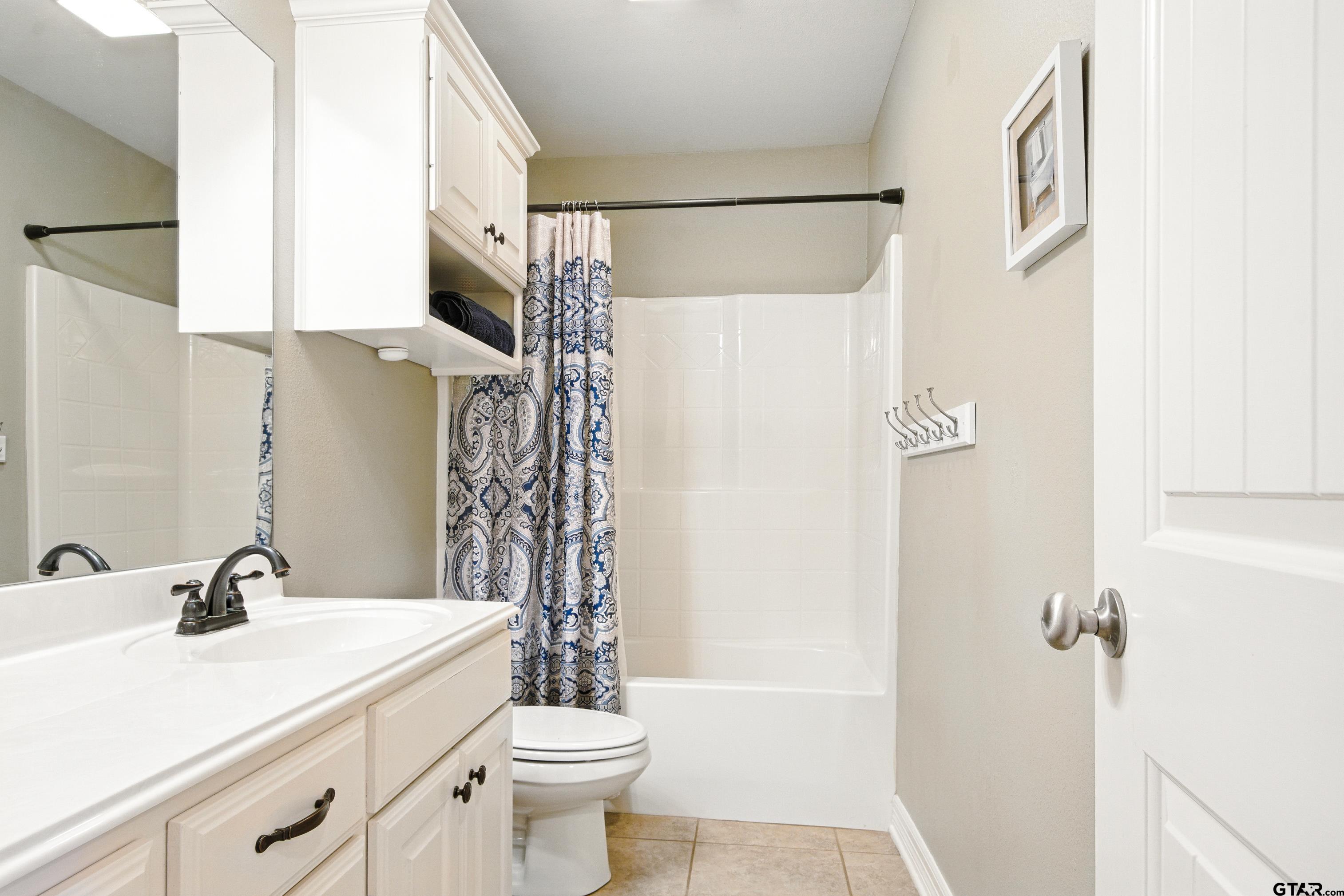 704 Windover Lane Bullard, TX 75757 - Photo 16 of 23 a bathroom with a sink a toilet and shower