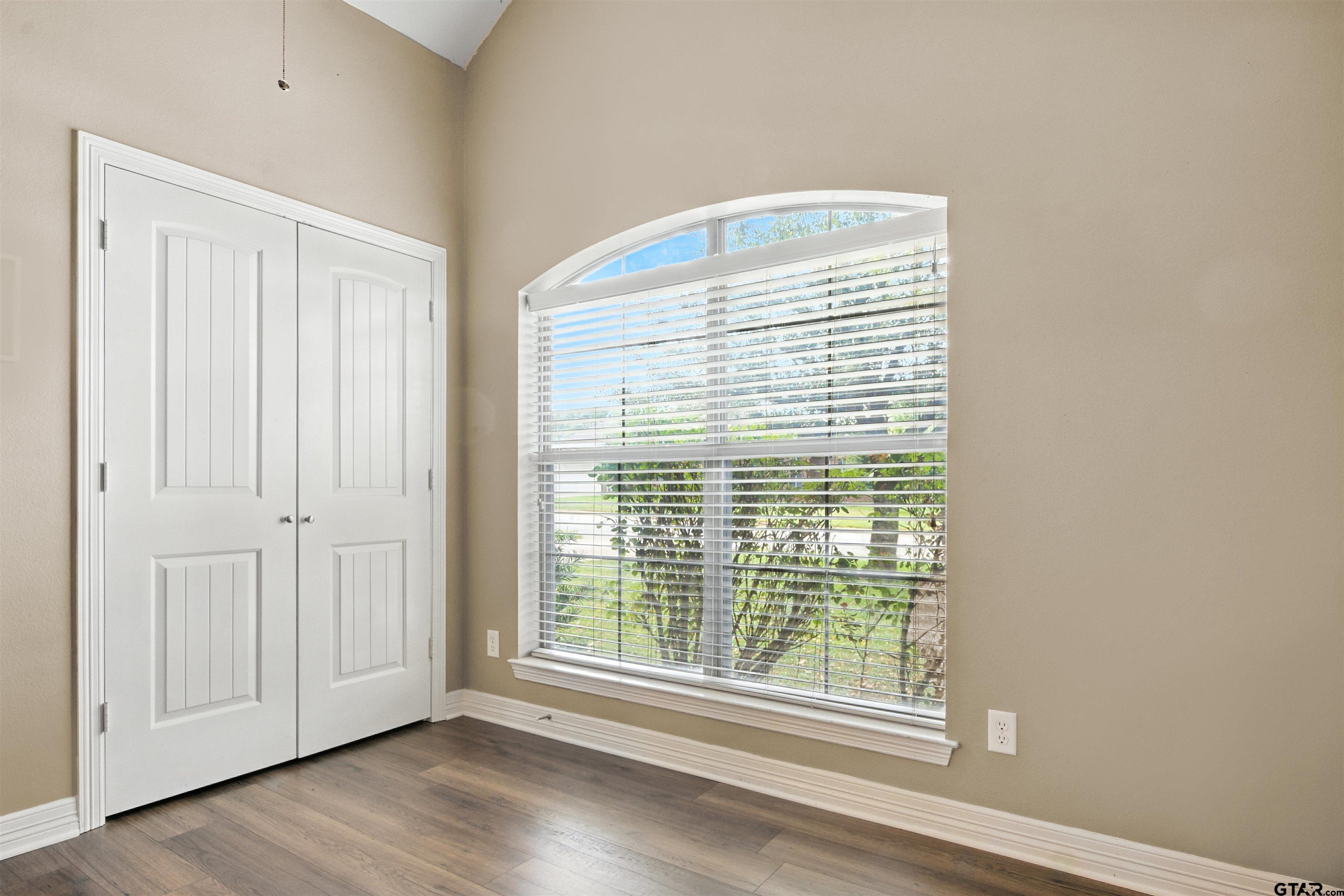 704 Windover Lane Bullard, TX 75757 - Photo 17 of 23 a view of an empty room with wooden floor and a window