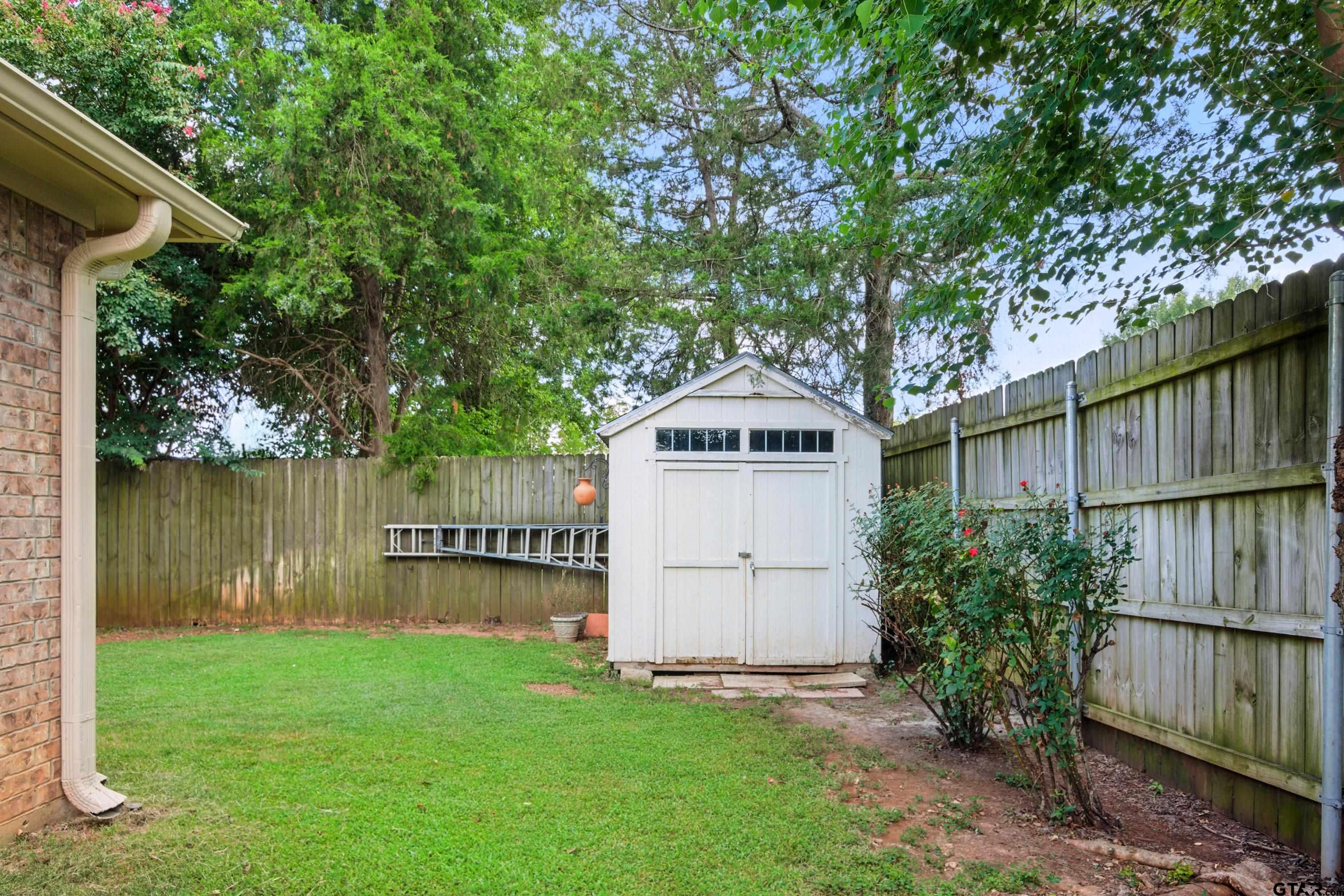 704 Windover Lane Bullard, TX 75757 - Photo 22 of 23 a view of a wooden house with a yard and a large tree