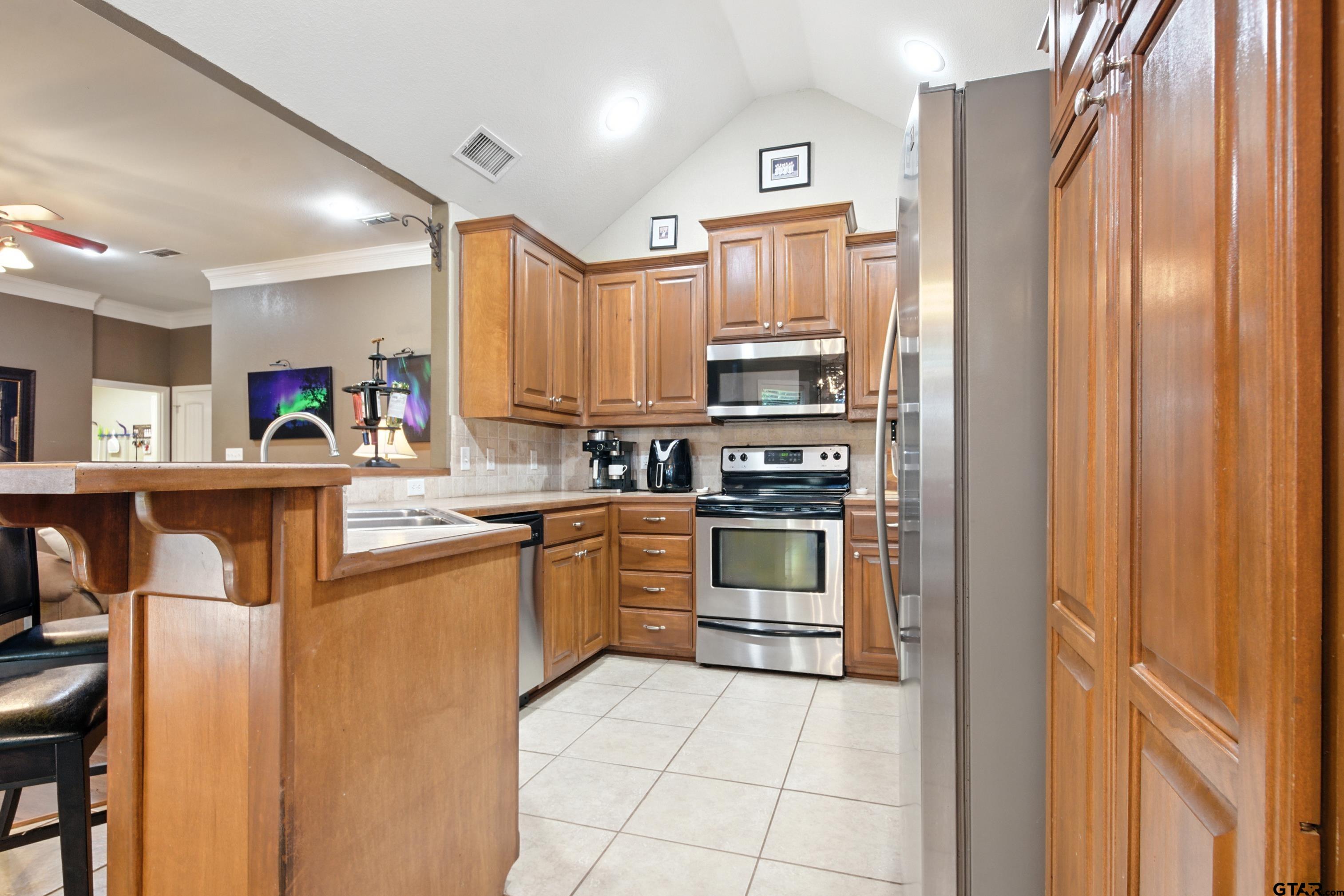 704 Windover Lane Bullard, TX 75757 - Photo 7 of 23 a kitchen with stainless steel appliances granite countertop a refrigerator sink and cabinets