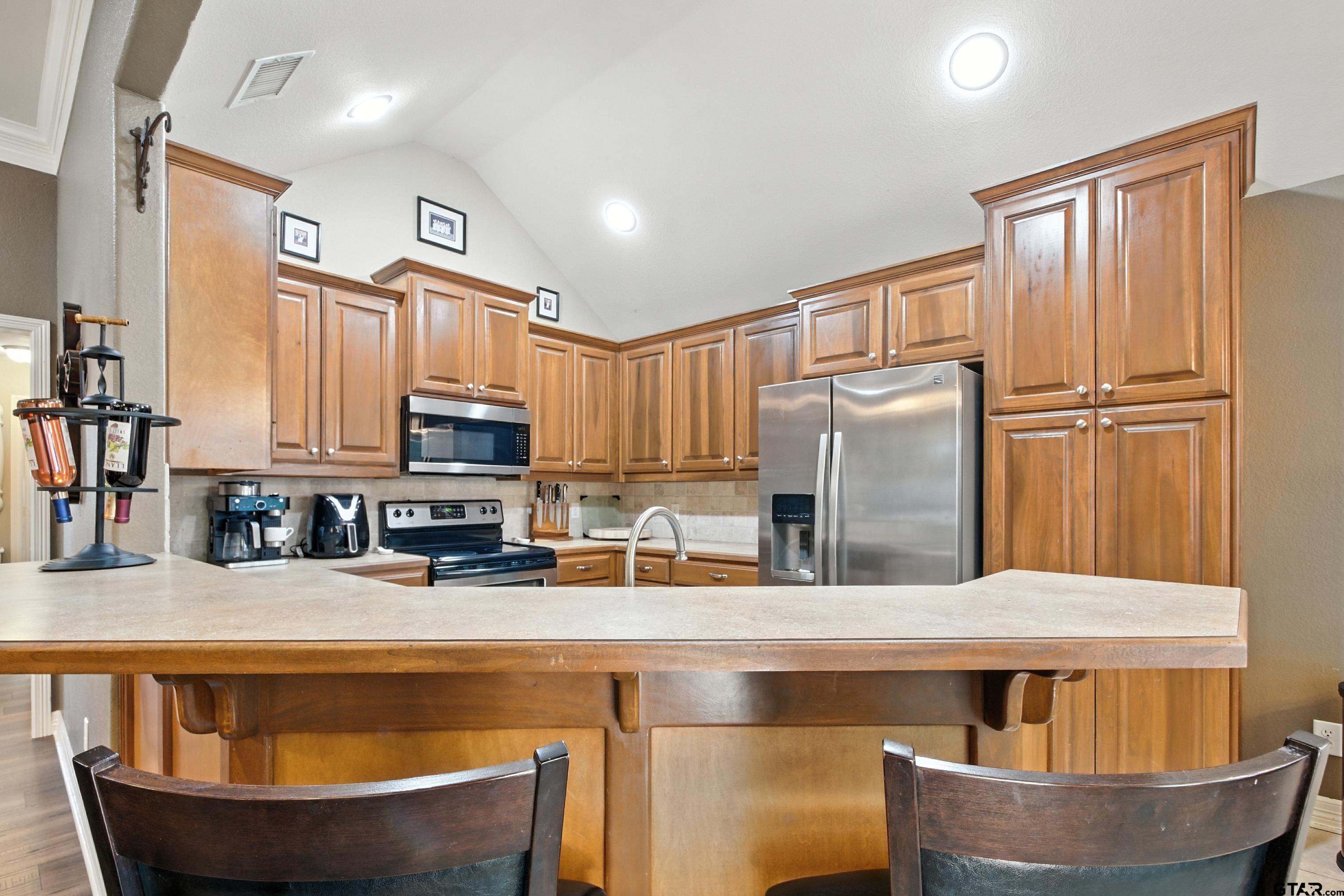 704 Windover Lane Bullard, TX 75757 - Photo 8 of 23 a kitchen with stainless steel appliances granite countertop a sink a stove and a refrigerator