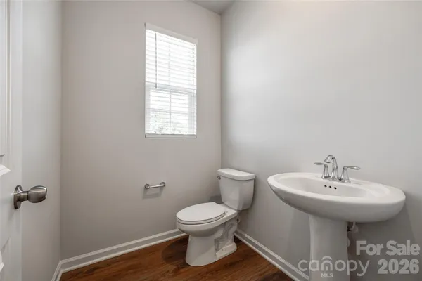 a bathroom with a sink toilet and a mirror