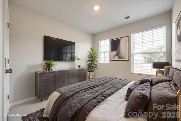 a bedroom with a bed and a flat screen television