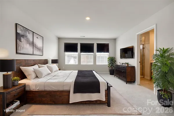 a bedroom with a bed and a television
