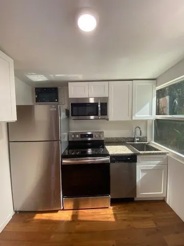 a kitchen with stainless steel appliances a stove a microwave and a refrigerator