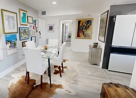 a living room with furniture and a painting on the wall