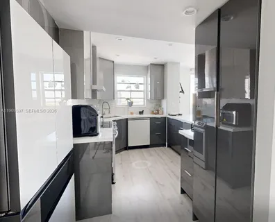 a kitchen with a refrigerator and a sink