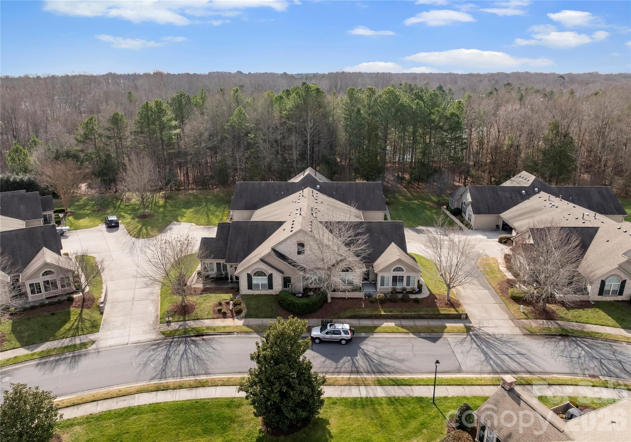 2304 Coltsview Lane Matthews, NC 28105 - Photo 28 of 36 an aerial view of a house with a garden and lake view