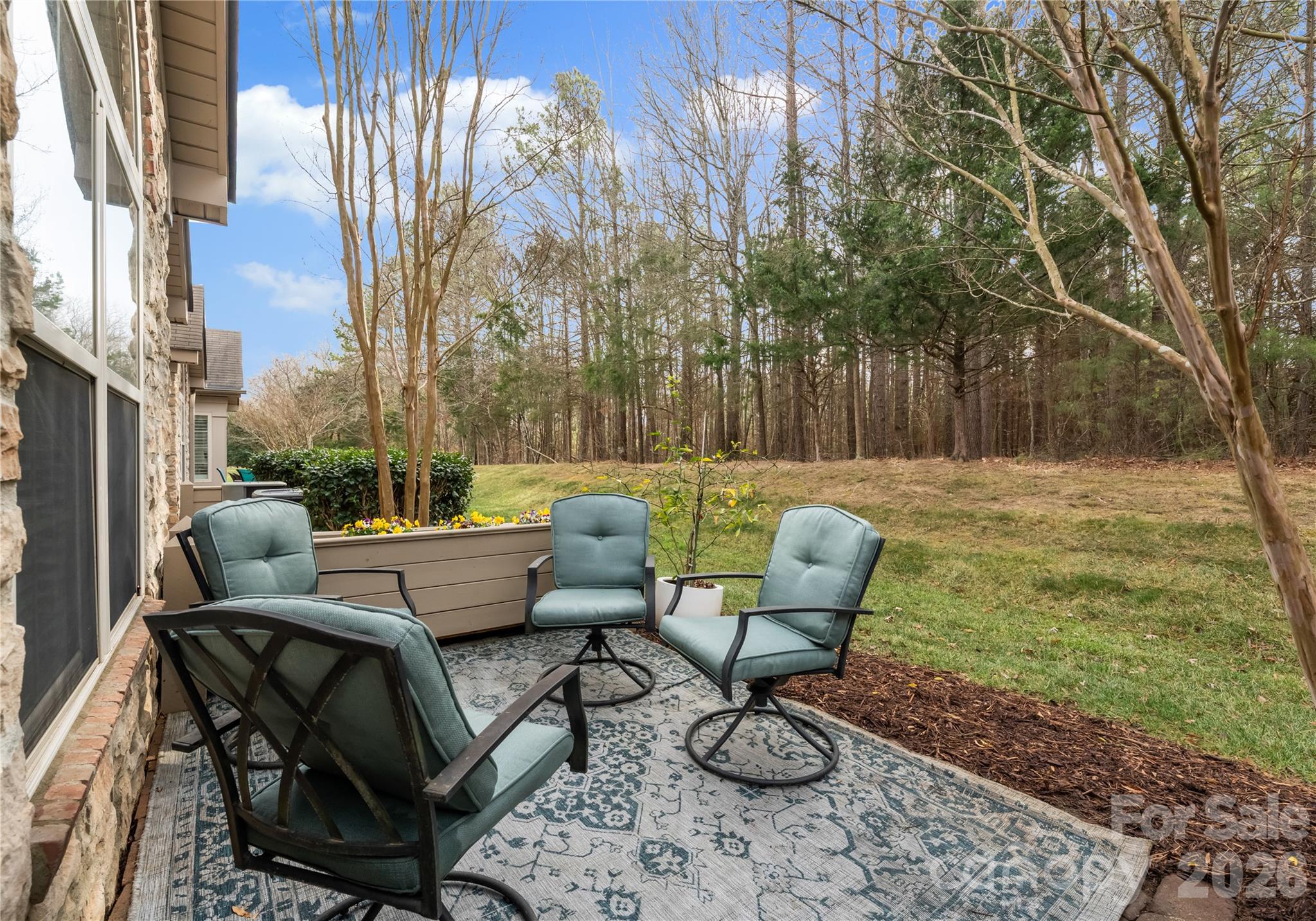 2304 Coltsview Lane Matthews, NC 28105 - Photo 35 of 36 a backyard of a house with table and chairs