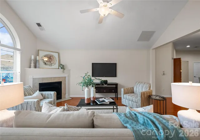 a living room with furniture fireplace and window