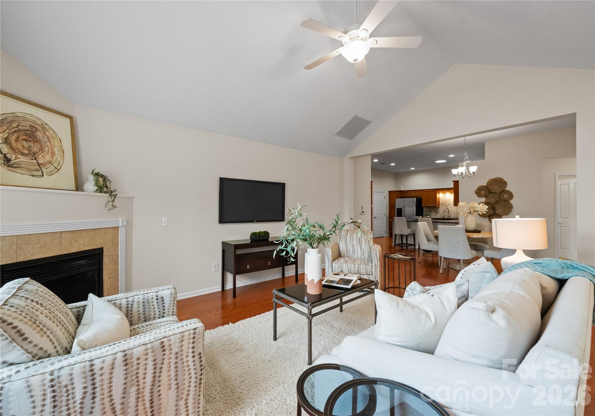2304 Coltsview Lane Matthews, NC 28105 - Photo 8 of 36 a living room with furniture a fireplace and a flat screen tv