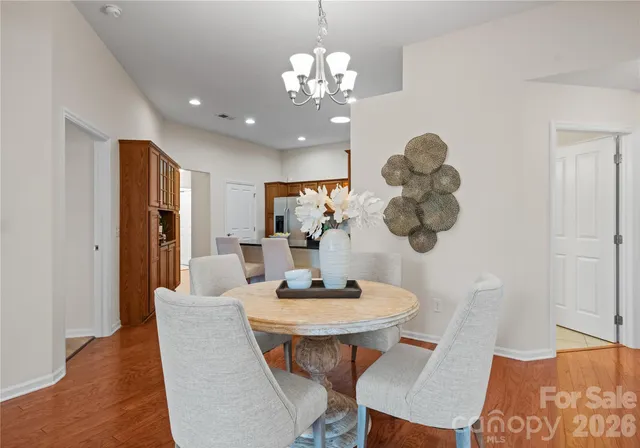 a dining room with furniture and chandelier