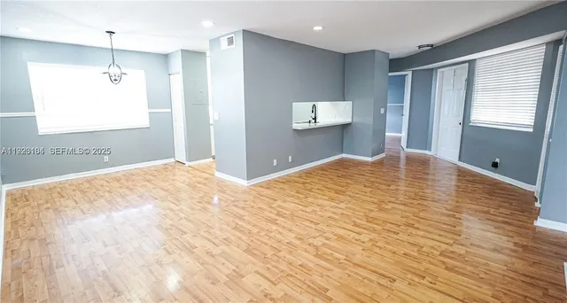 a large bedroom with wooden floor