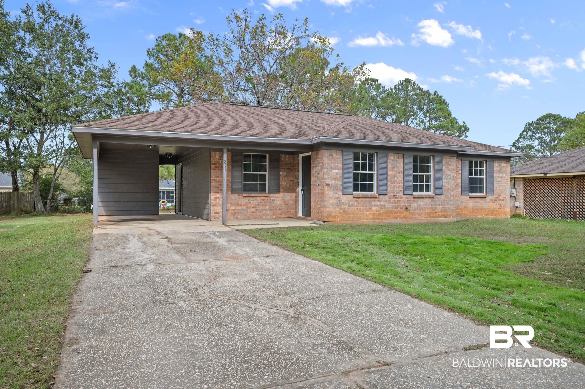811 East Verbena Avenue Foley, AL 36535 - Photo 1 of 16 Single story home featuring a front lawn and a carport