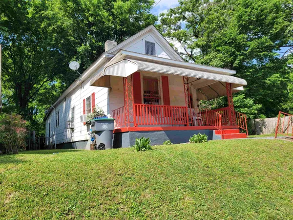 a view of a house with a yard and sitting area