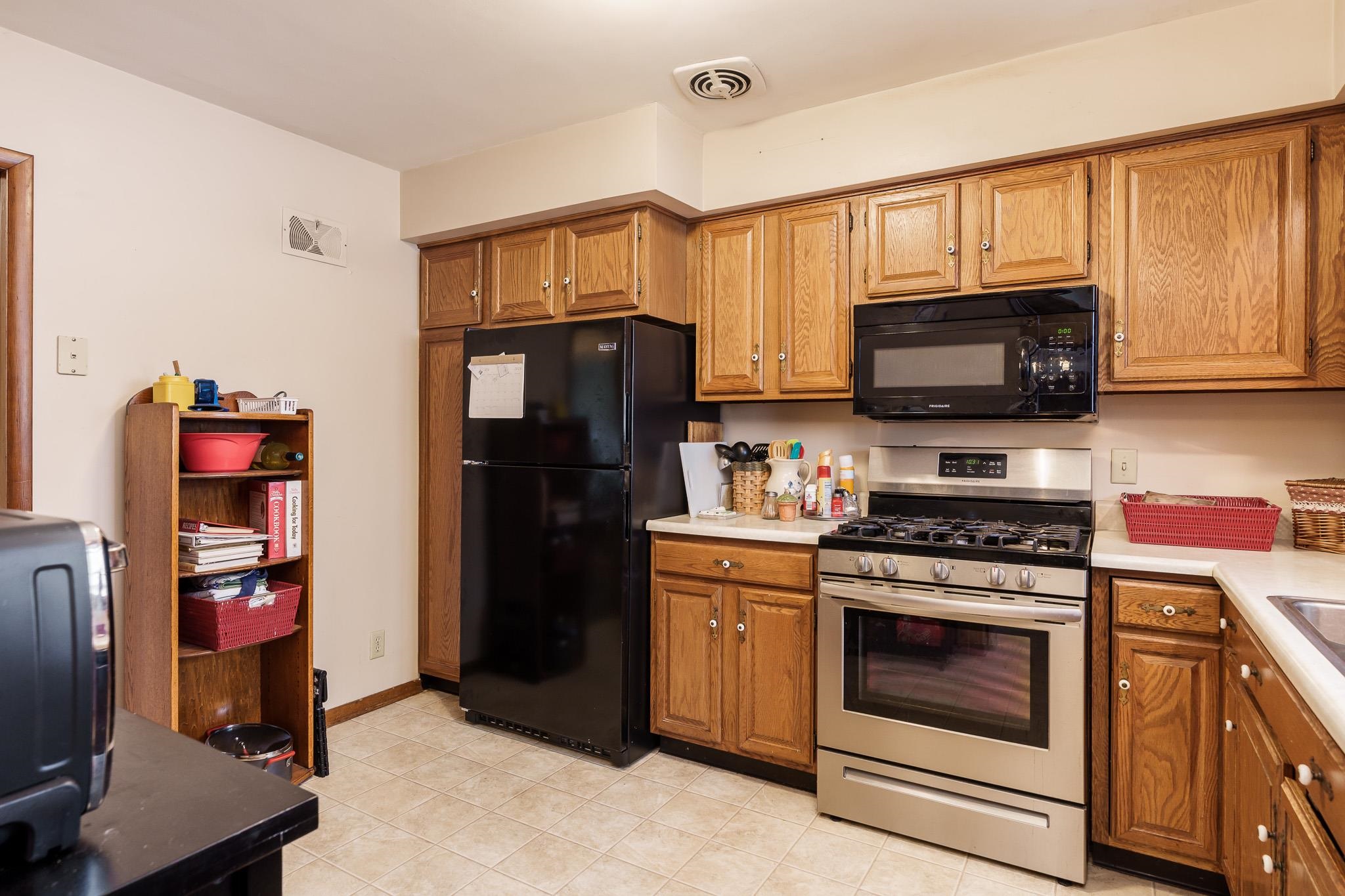 3704 Highcrest Road Rockford, IL 61107 - Photo 13 of 33 a kitchen with stainless steel appliances granite countertop a stove a refrigerator and a microwave