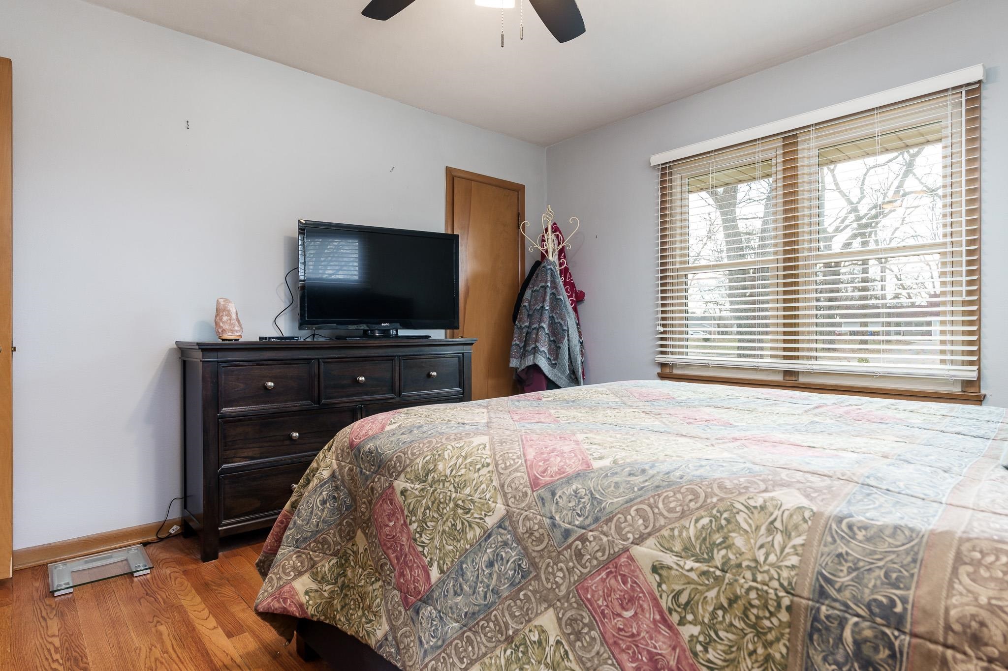 3704 Highcrest Road Rockford, IL 61107 - Photo 20 of 33 a bedroom with a bed and a flat screen tv