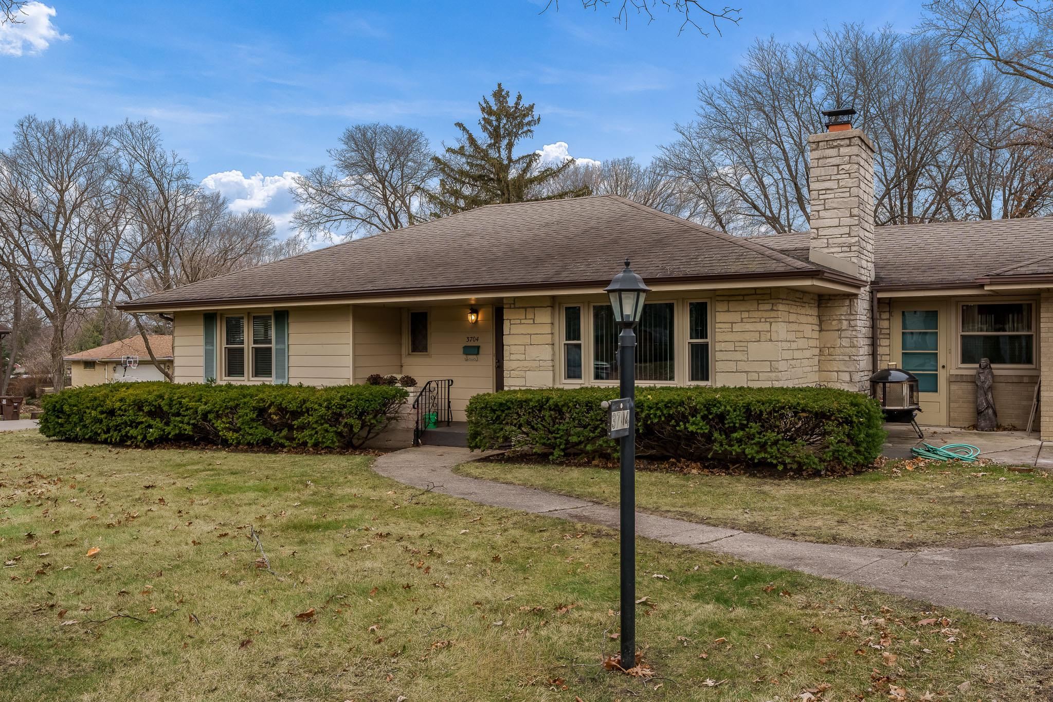 3704 Highcrest Road Rockford, IL 61107 - Photo 2 of 33 a front view of a house with yard and green space