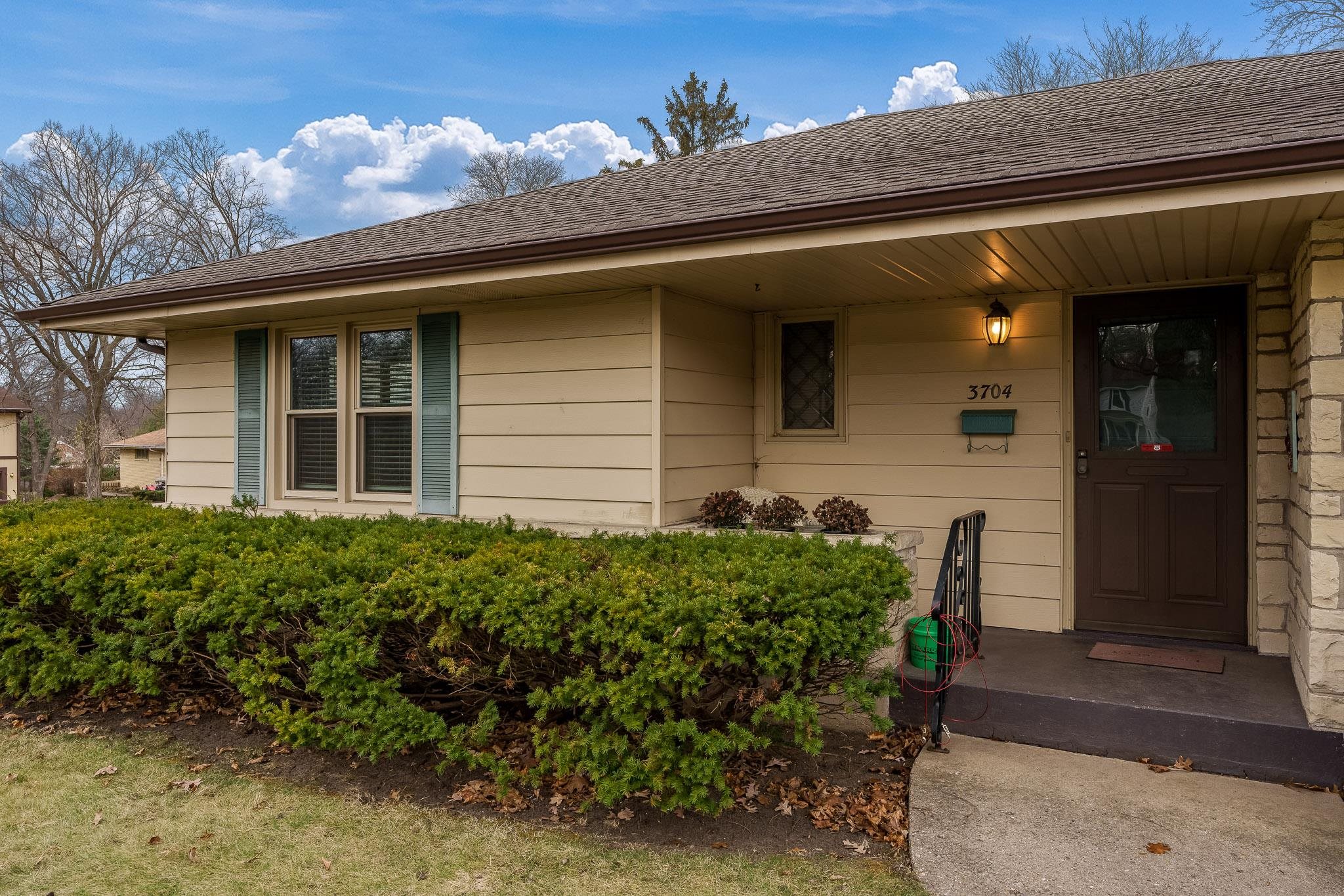 3704 Highcrest Road Rockford, IL 61107 - Photo 3 of 33 a view of a house with a large window and flower plants