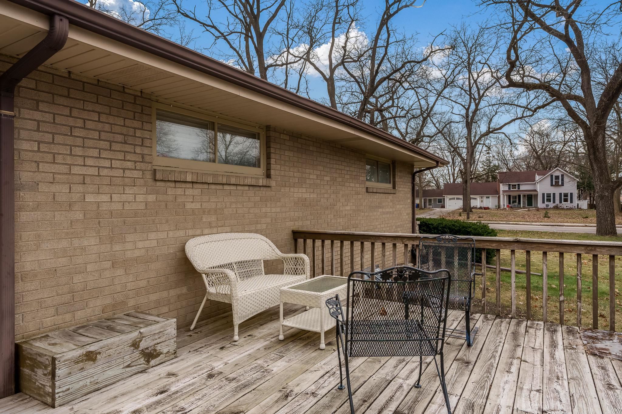 3704 Highcrest Road Rockford, IL 61107 - Photo 32 of 33 a view of a patio with table and chairs with wooden floor and fence