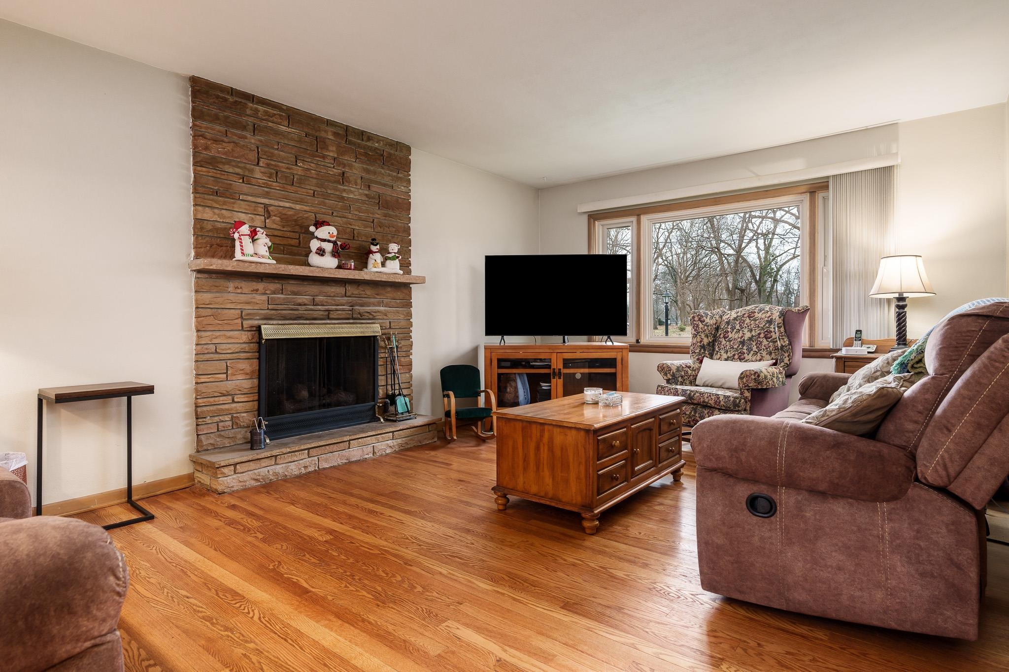 3704 Highcrest Road Rockford, IL 61107 - Photo 6 of 33 a living room with furniture and a flat screen tv