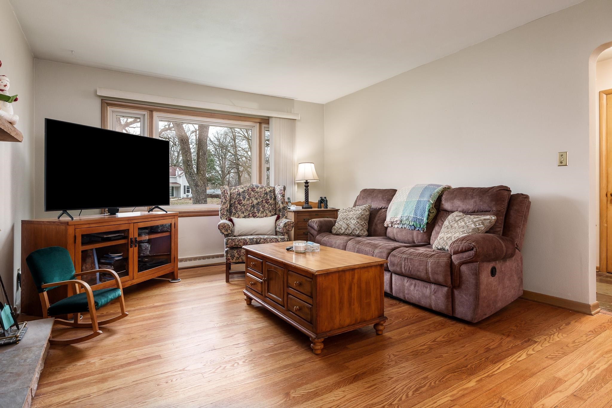 3704 Highcrest Road Rockford, IL 61107 - Photo 7 of 33 a living room with furniture and a flat screen tv