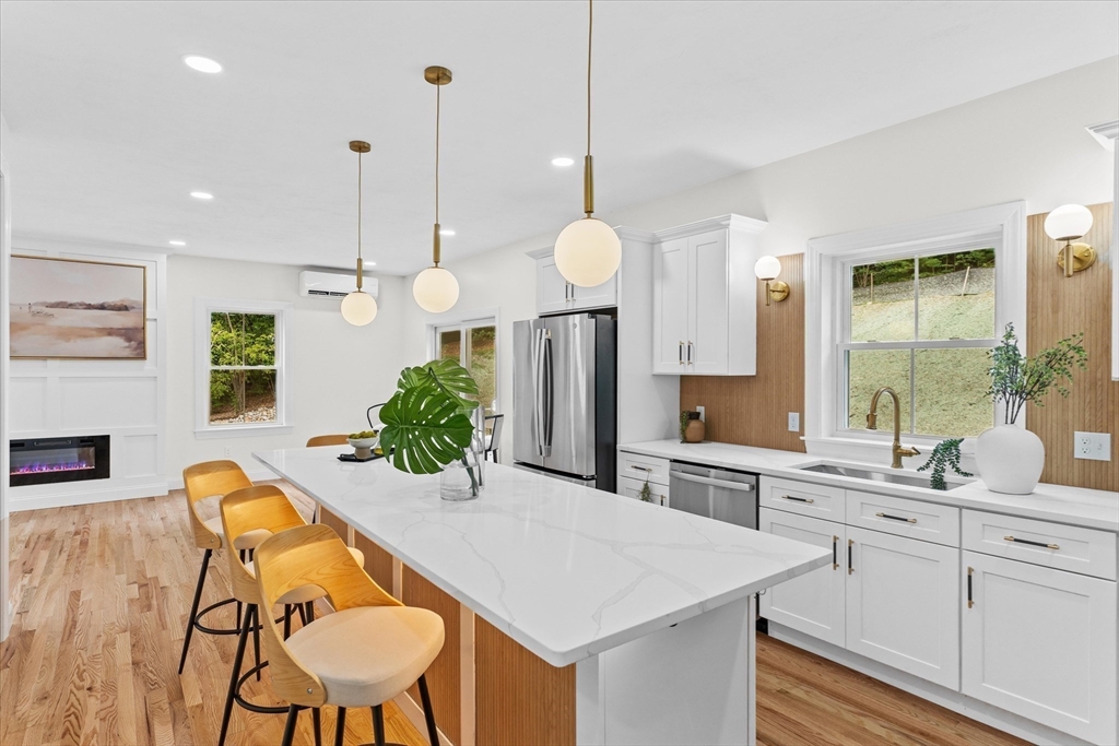 508 Pine Street Leicester, MA 01524 - Photo 2 of 34 a kitchen with a table chairs sink and cabinets