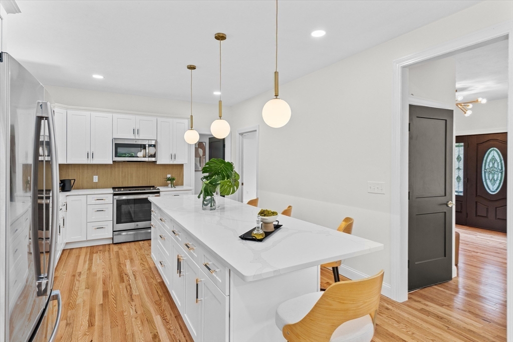 508 Pine Street Leicester, MA 01524 - Photo 6 of 34 a kitchen with white cabinets and stainless steel appliances