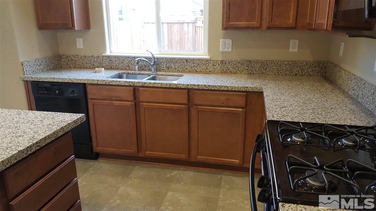 2360 Soprano Drive Reno, NV 89521 - Photo 4 of 6 a kitchen with a sink stove and cabinets