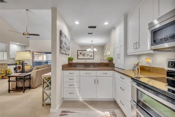 a spacious bathroom with a granite countertop sink a mirror and a shower