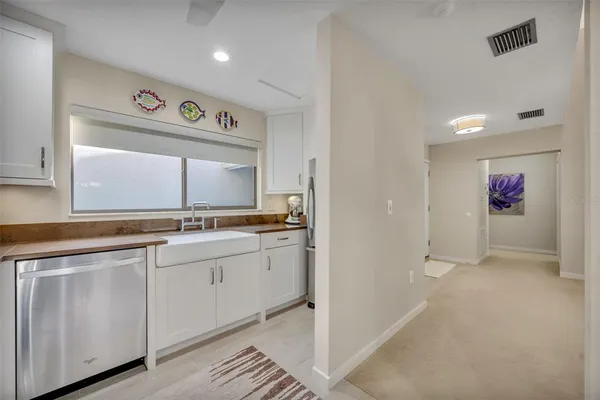 a kitchen with granite countertop a stove microwave and sink