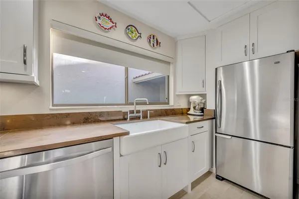 a bedroom with a bed and a flat tv screen on dresser