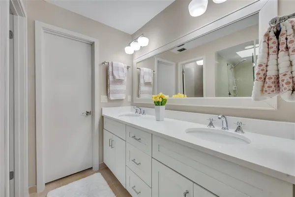 a bathroom with a tub shower and window
