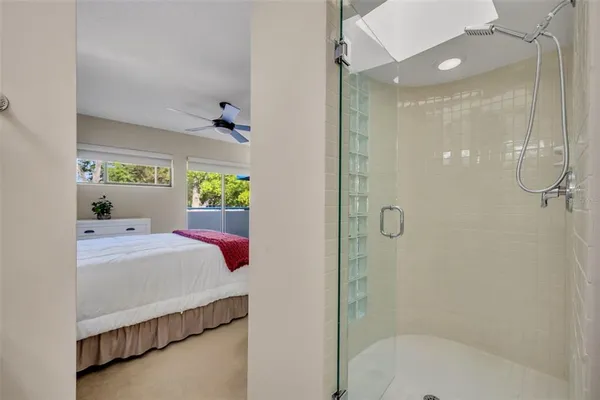 a bedroom with a bed and a ceiling fan