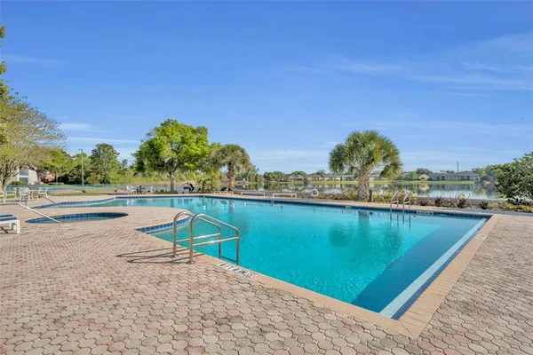 a view of swimming pool and trees in the background