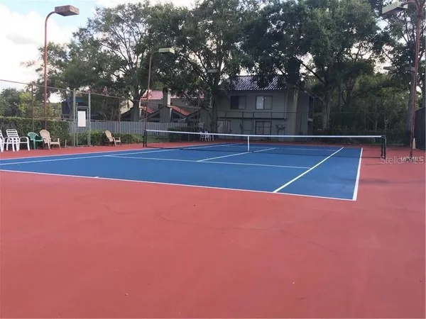 an aerial view of lake and residential houses with outdoor space
