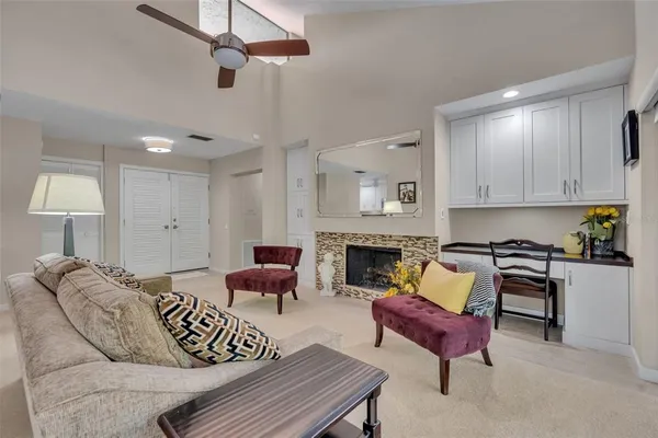 a living room with furniture and a chandelier