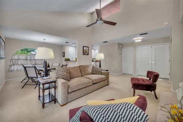 a living room with furniture a fireplace and a lamp