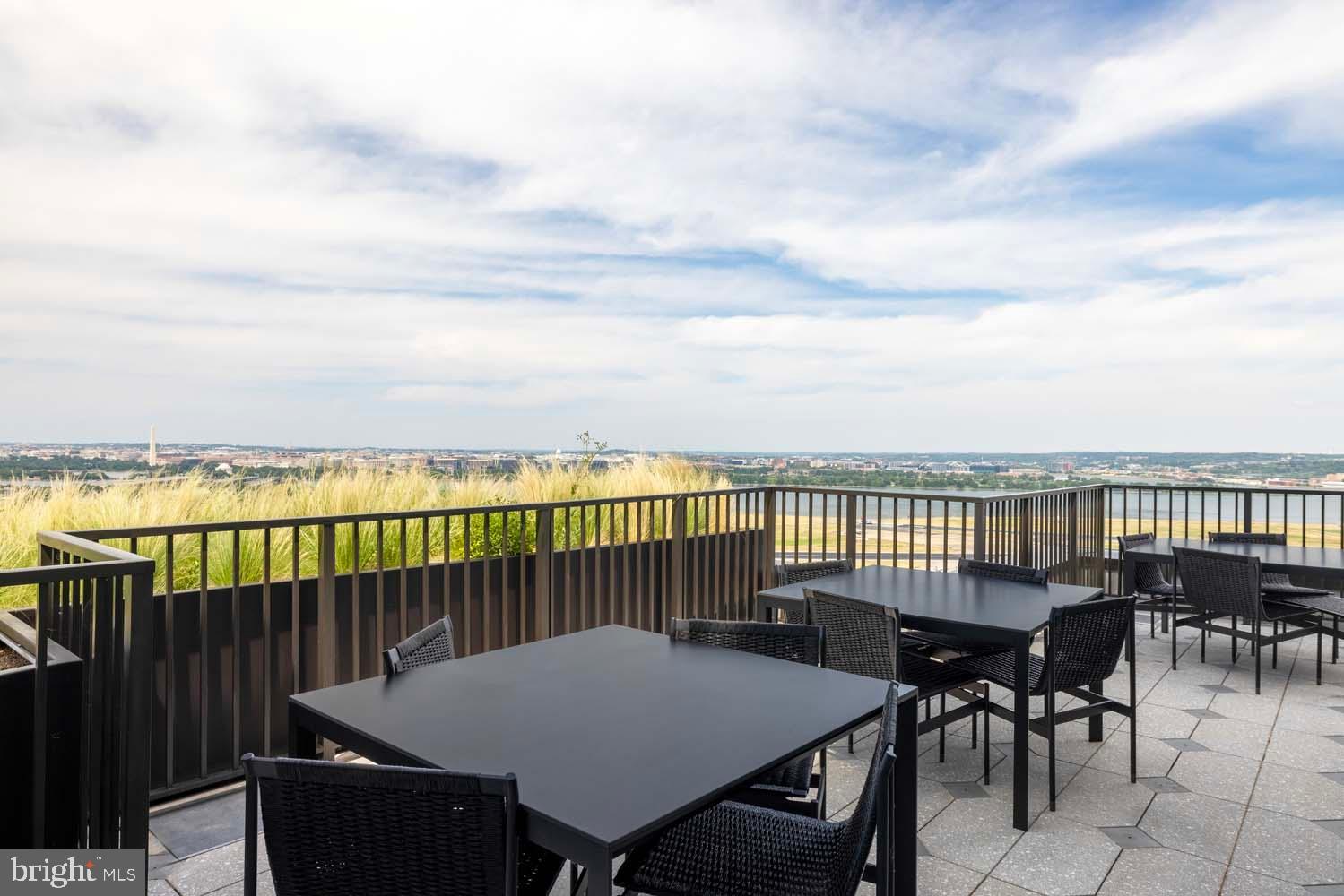 269 19th Court South, Unit PH2302 Arlington, VA 22202 - Photo 17 of 28 a view of a chairs and table on the terrace