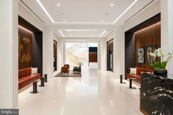 a kitchen with a sink and chairs