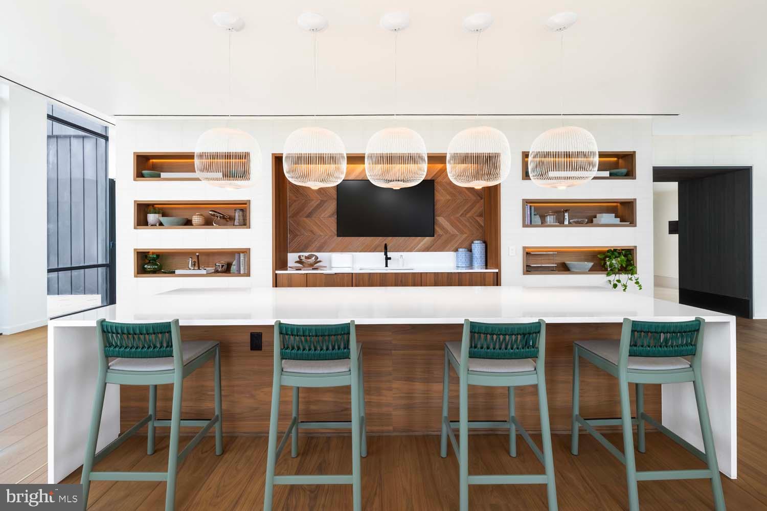 269 19th Court South, Unit PH2302 Arlington, VA 22202 - Photo 20 of 28 a kitchen with a sink and chairs