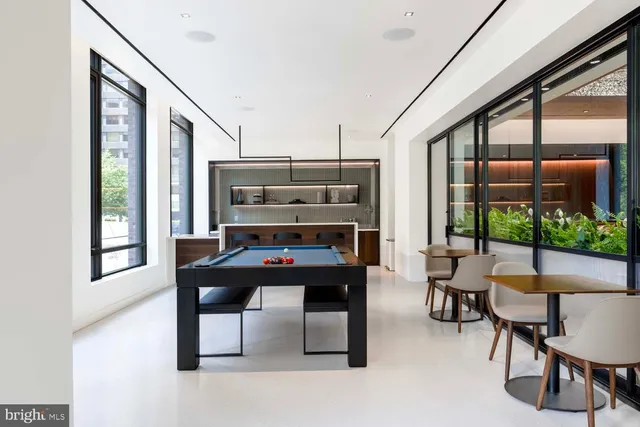 a swimming pool with outdoor seating and yard