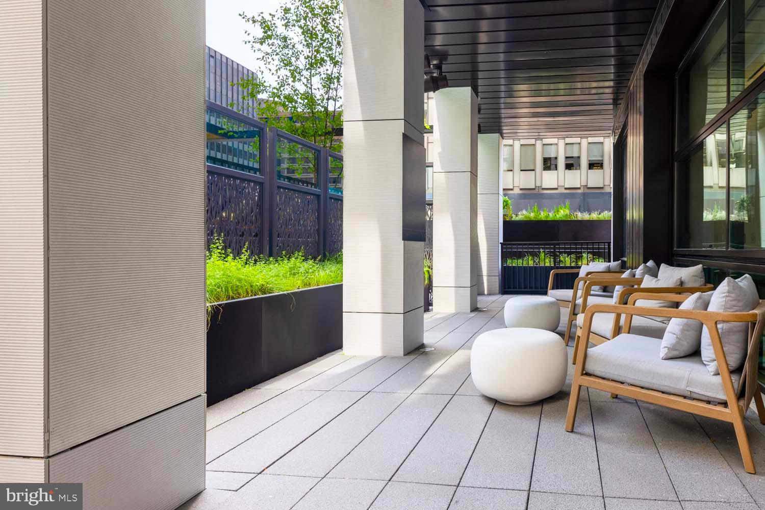 269 19th Court South, Unit PH2302 Arlington, VA 22202 - Photo 26 of 28 a outdoor space with patio the couches and a potted plant