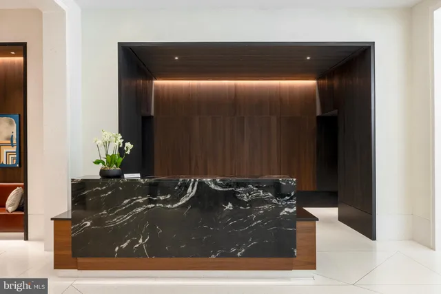 a hallway with a fireplace and a wooden floor