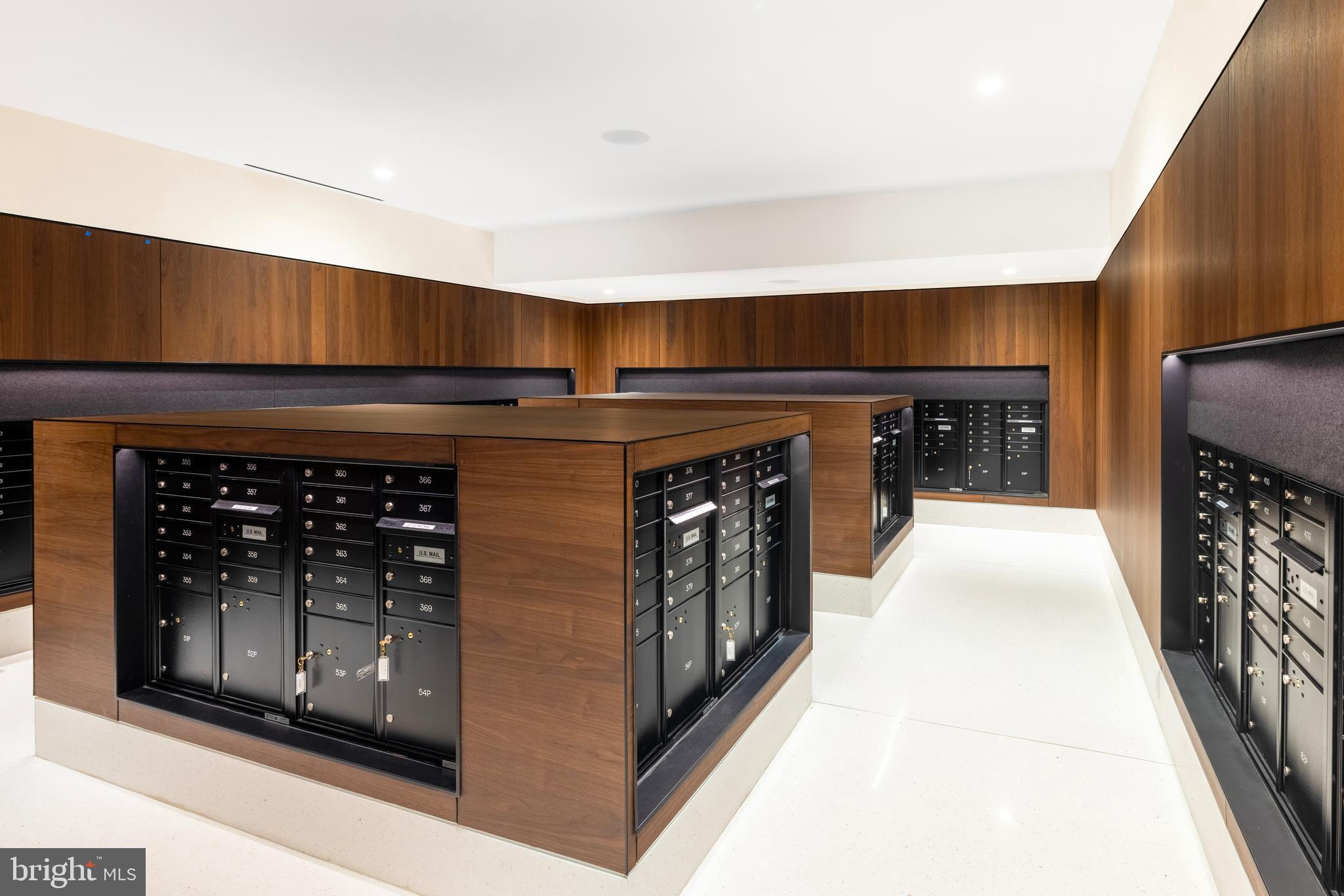 269 19th Court South, Unit PH2302 Arlington, VA 22202 - Photo 7 of 28 a hallway with a fireplace and a wooden floor
