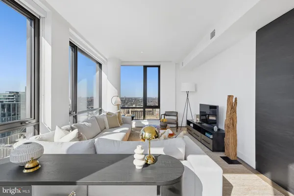 a view of a elevator with a potted plant on a table and a painting on the wall