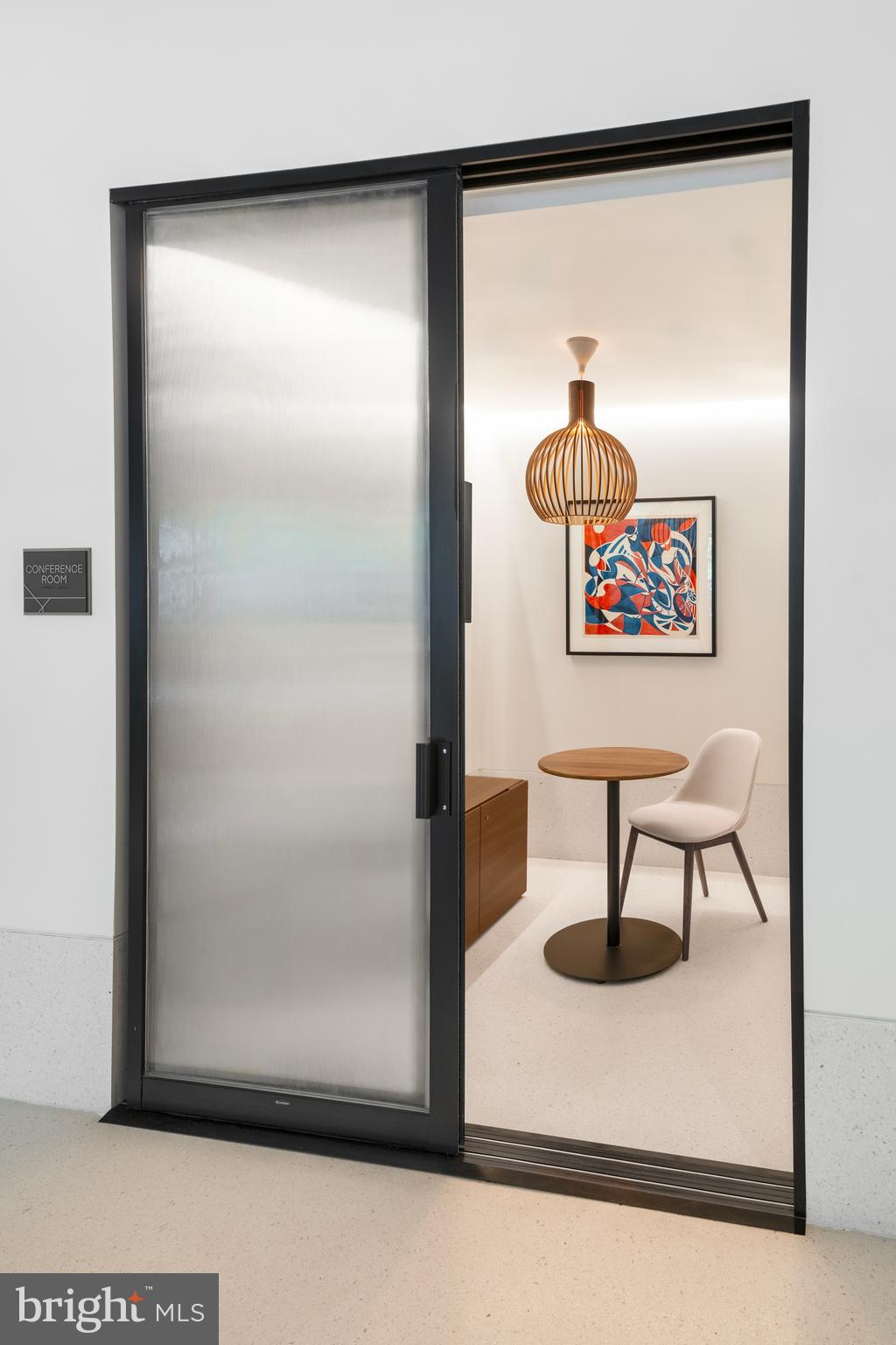 269 19th Court South, Unit PH2302 Arlington, VA 22202 - Photo 8 of 28 a view of a elevator with a potted plant on a table and a painting on the wall