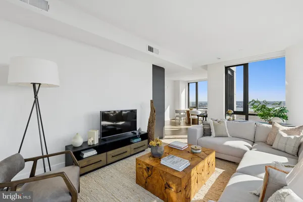a view of a livingroom with furniture and floor to ceiling window